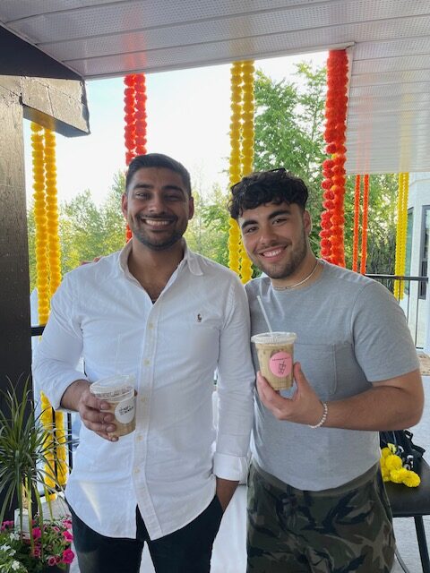 Happy Sip & Social customers holding their drinks into the camera and smiling